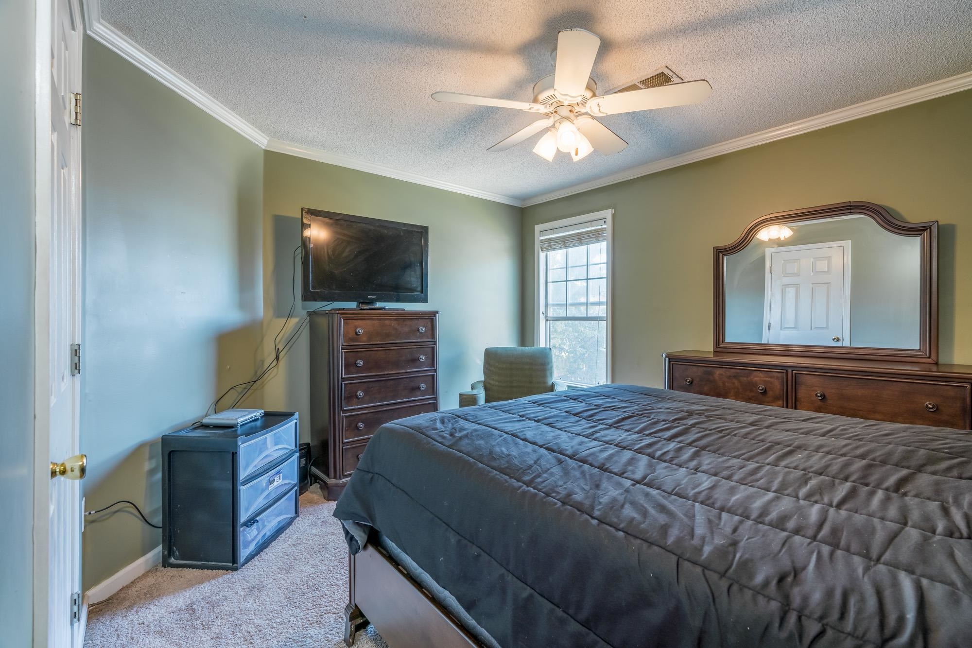 8599 Brer Fox Cove Memphis, TN 38018 - Photo 19 of 25 a bedroom with a bed and a flat screen tv