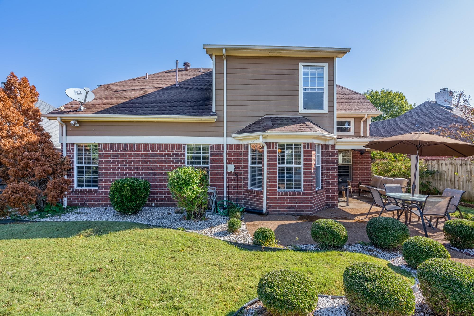 8599 Brer Fox Cove Memphis, TN 38018 - Photo 22 of 25 a front view of a house with garden and porch