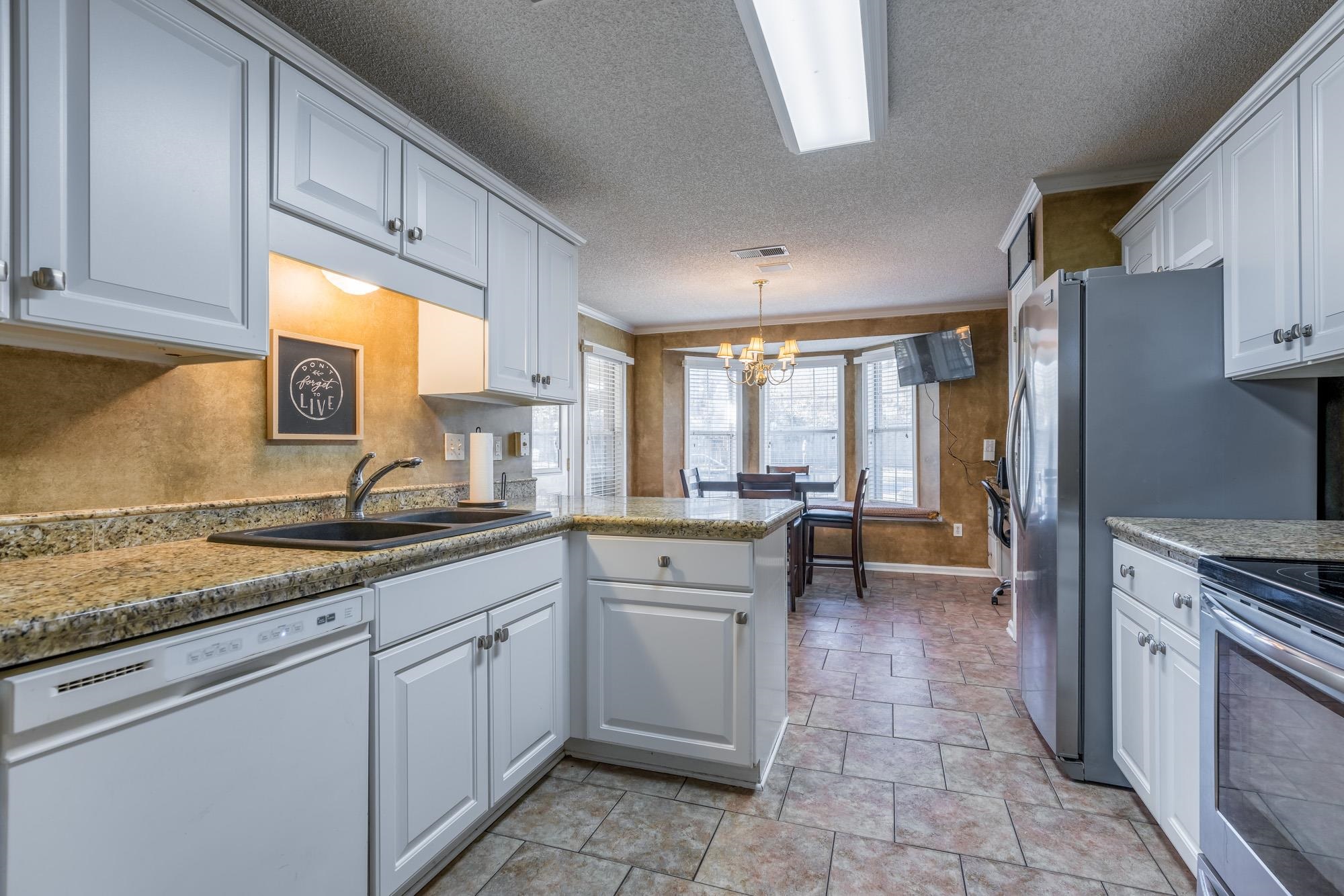 8599 Brer Fox Cove Memphis, TN 38018 - Photo 10 of 25 a kitchen with a sink stove and cabinets
