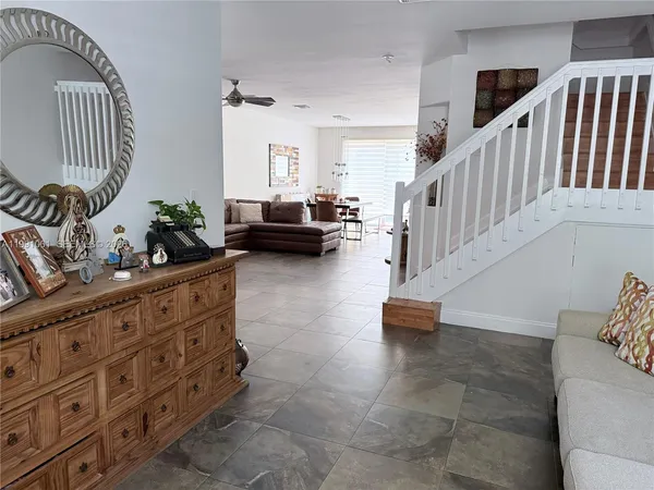 a living room with furniture and a chandelier