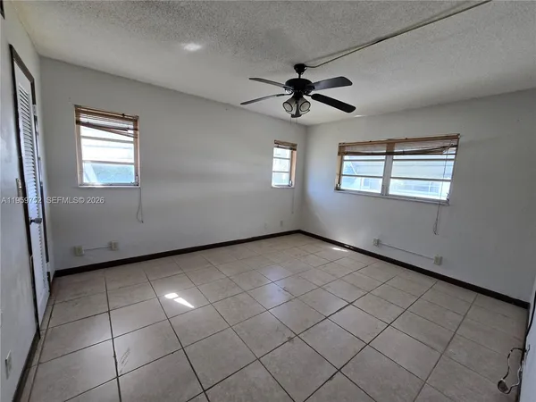 a view of a livingroom with a ceiling fan and window