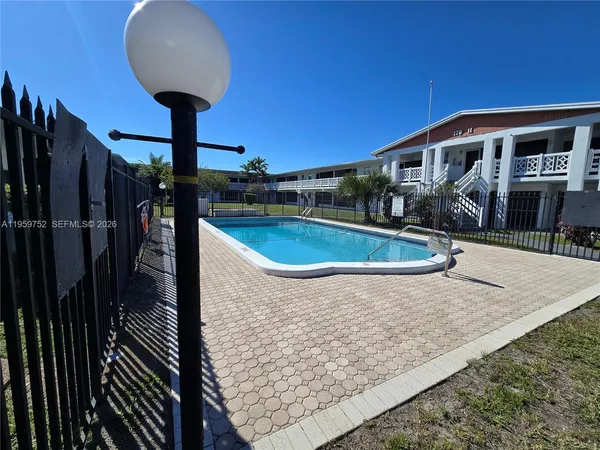 a view of a house with swimming pool and sitting space