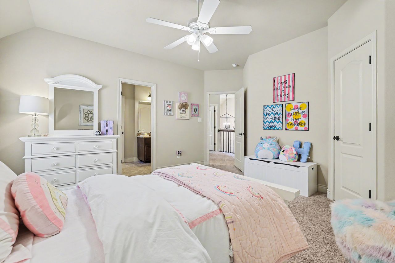 809 Prairie Dunes Drive Georgetown, TX 78628 - Photo 32 of 40 A well-appointed bedroom features a ceiling fan, carpet flooring, and a private ensuite bathroom.
