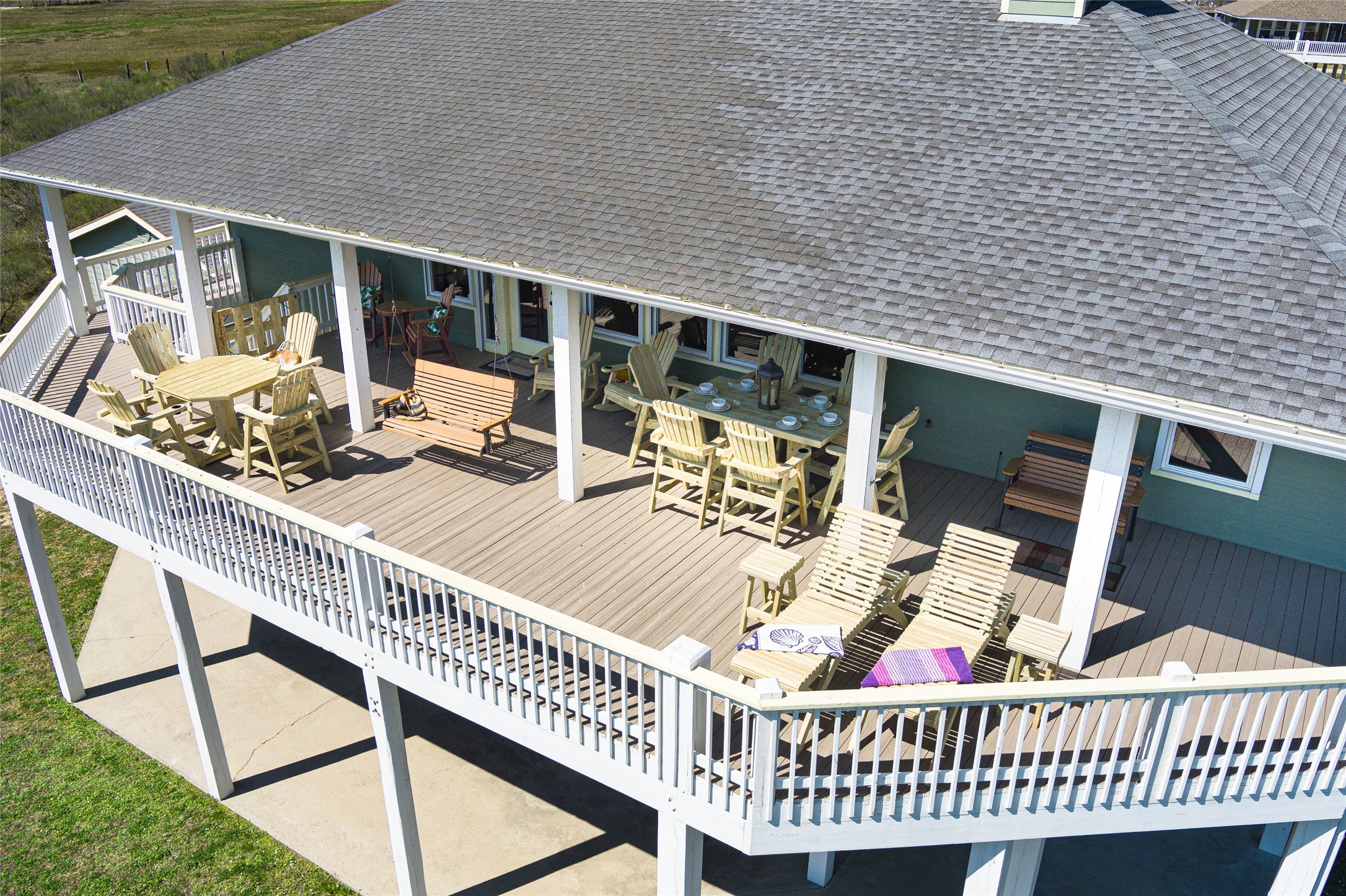 a roof deck with table and chairs and potted plants