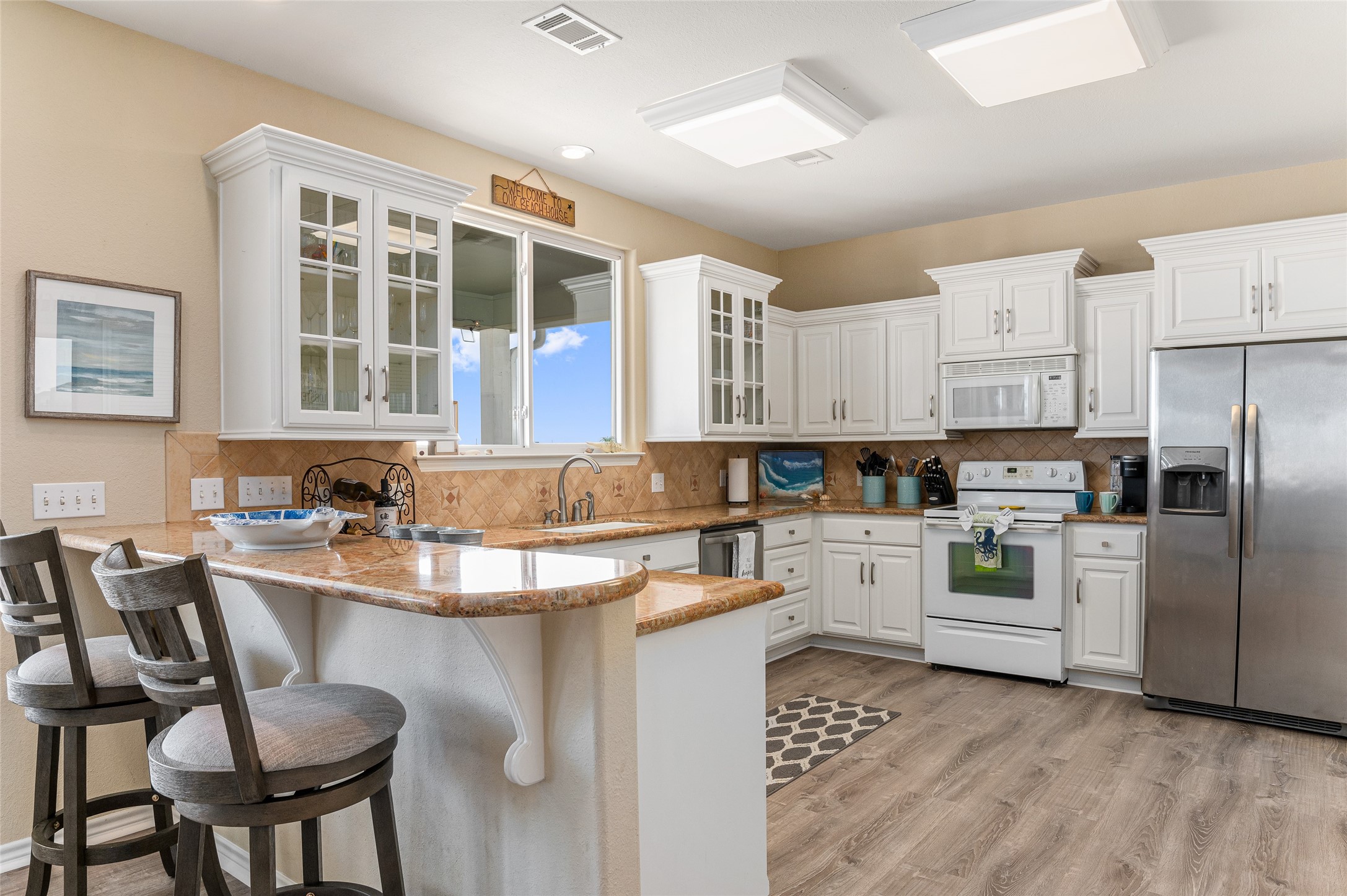 200 Mobile Crystal Beach, TX 77650 - Photo 16 of 49 a kitchen with a stove a sink and white cabinets