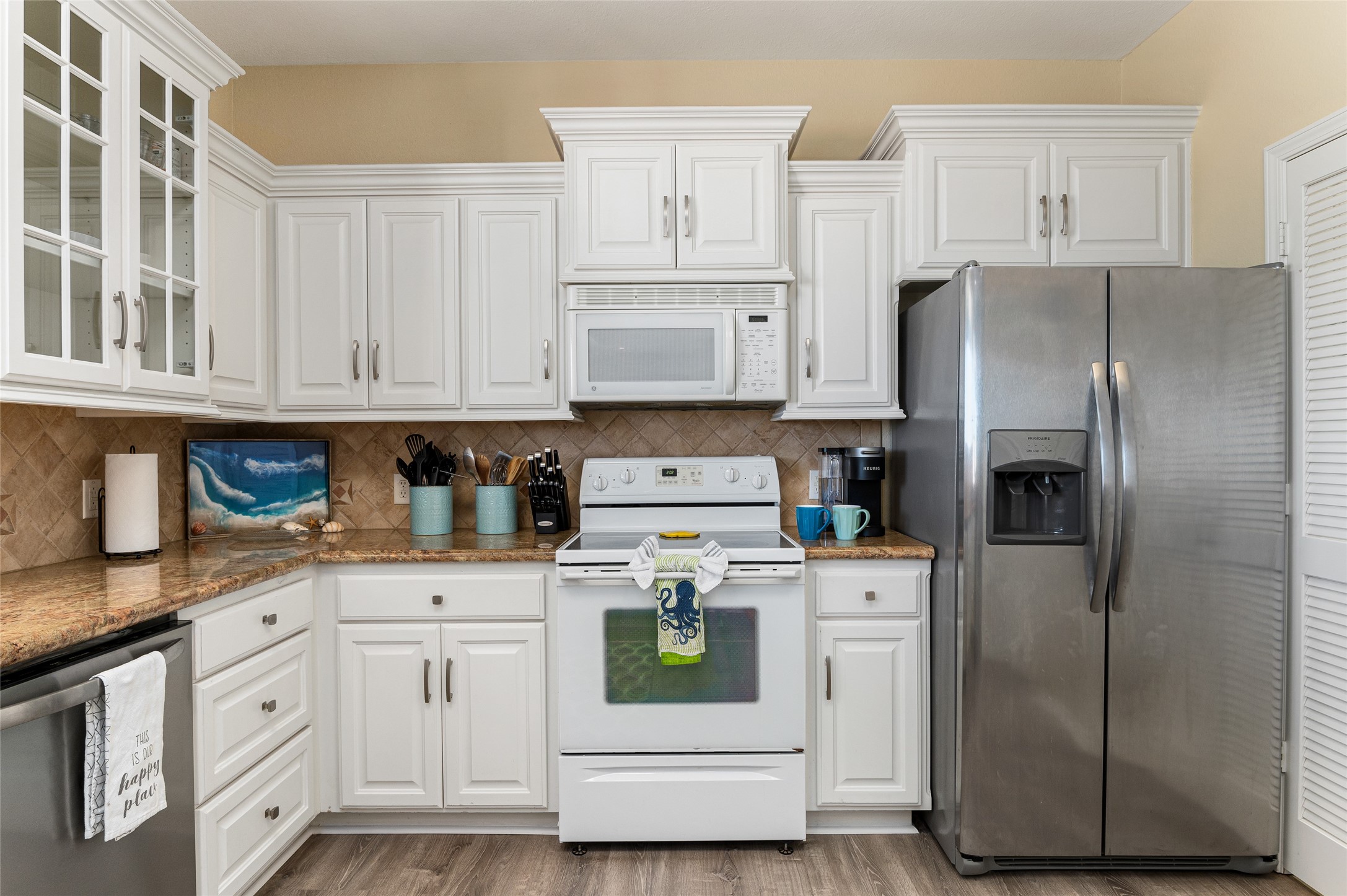 200 Mobile Crystal Beach, TX 77650 - Photo 17 of 49 a kitchen with white cabinets and white stainless steel appliances