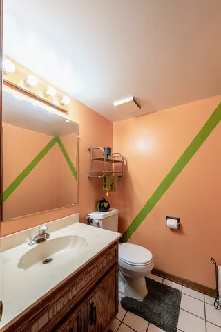 a bathroom with a sink a toilet and mirror