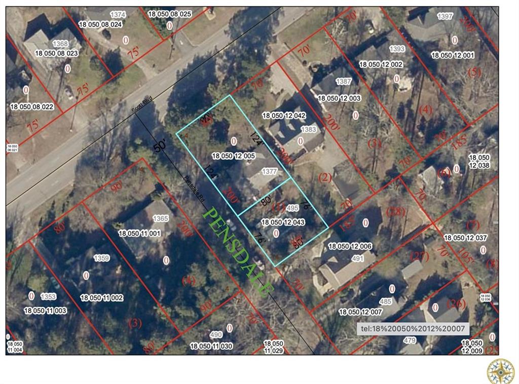 an aerial view of a residential apartment building with a yard and parking