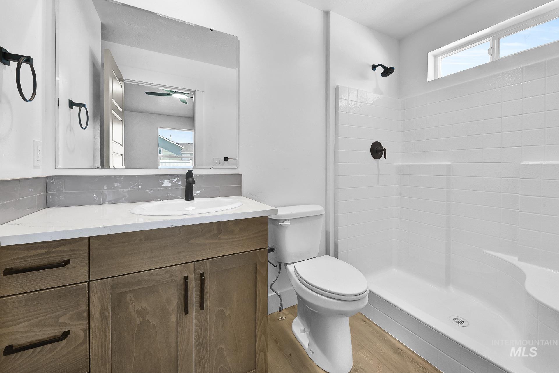 1162 Velvet Loop Wilder, ID 83676 - Photo 18 of 31 Bathroom with light wood finished floors, a shower, and vanity