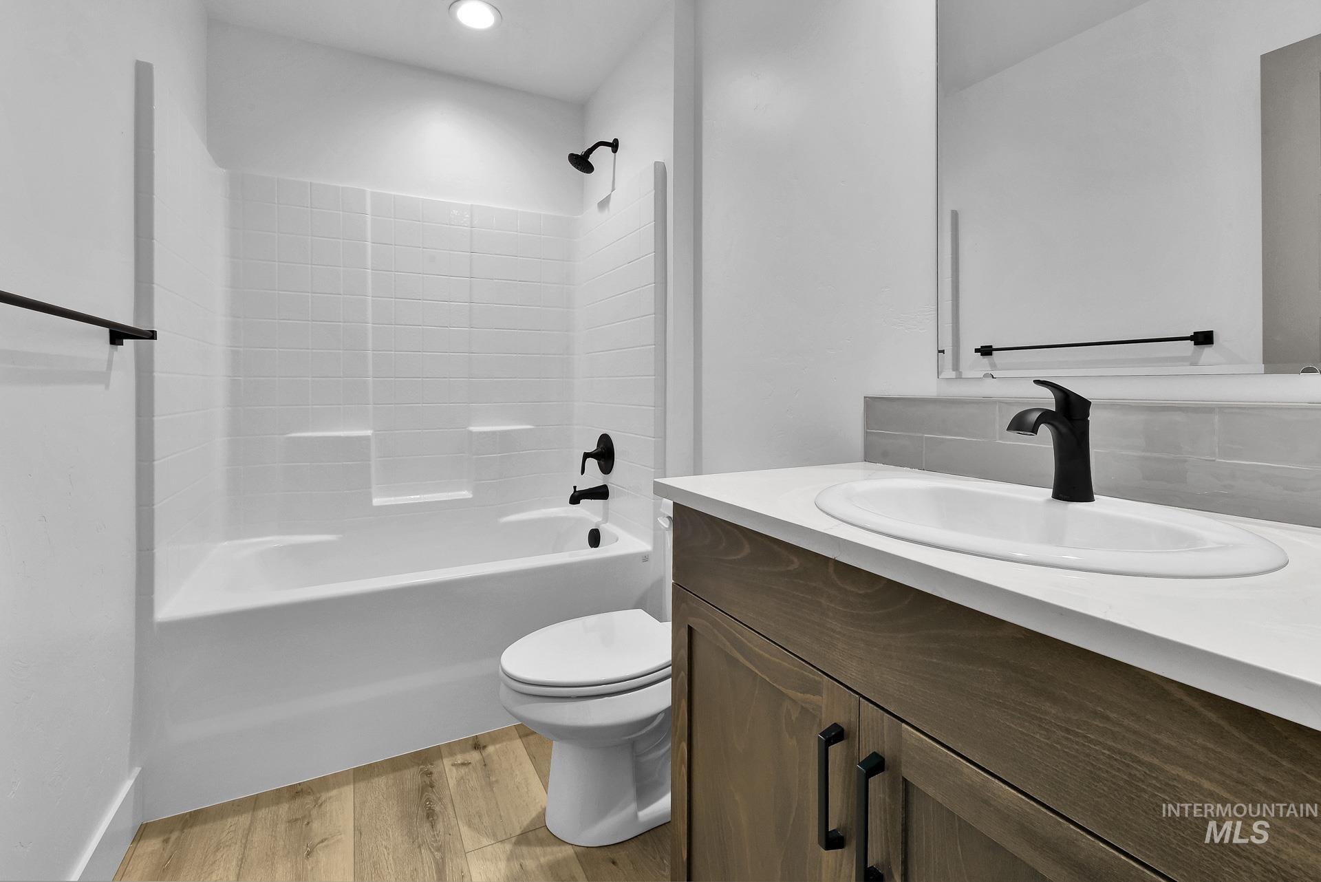 1162 Velvet Loop Wilder, ID 83676 - Photo 21 of 31 Full bath with vanity, washtub / shower combination, light wood-style floors, and recessed lighting
