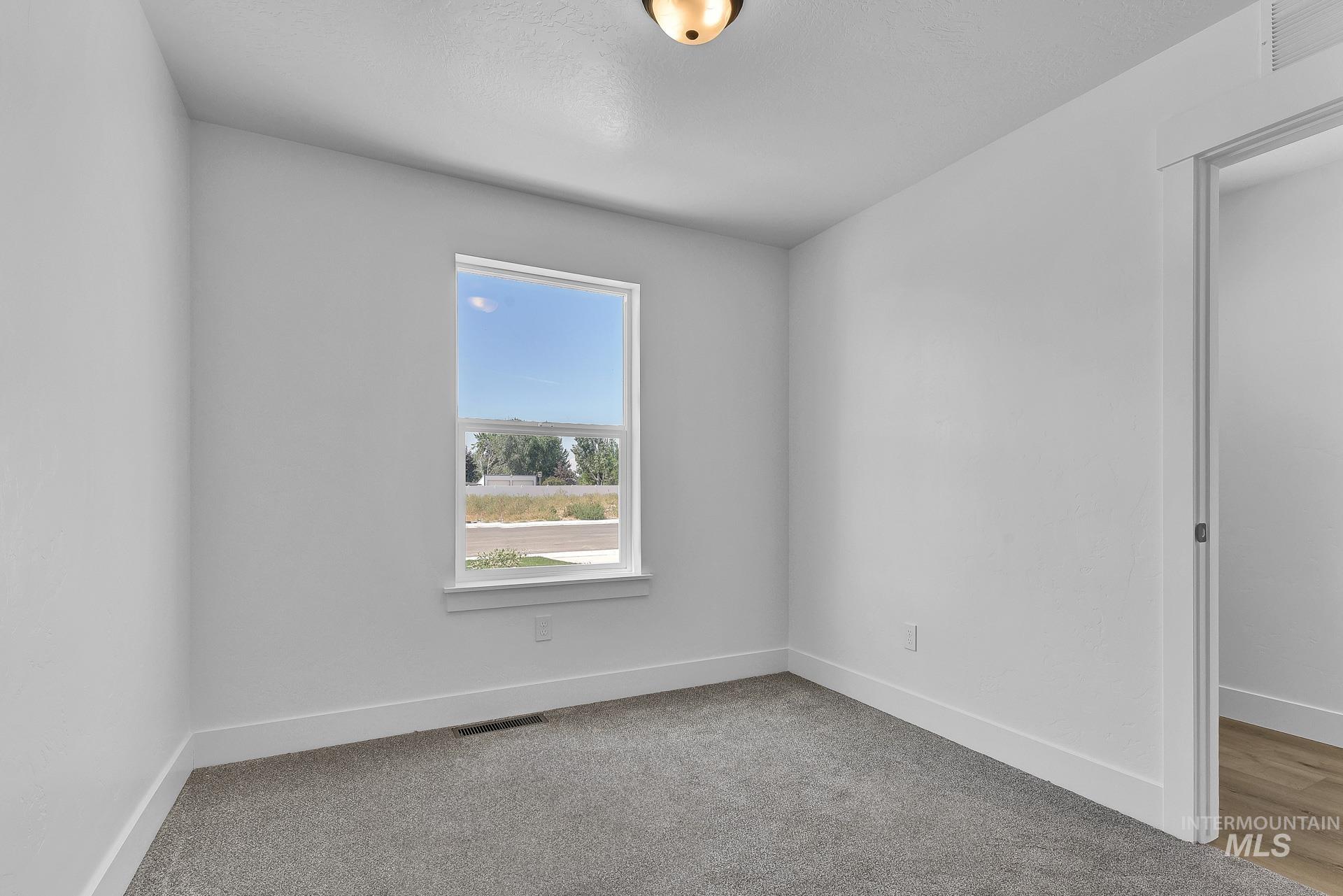 1162 Velvet Loop Wilder, ID 83676 - Photo 25 of 31 Spare room featuring baseboards and light colored carpet