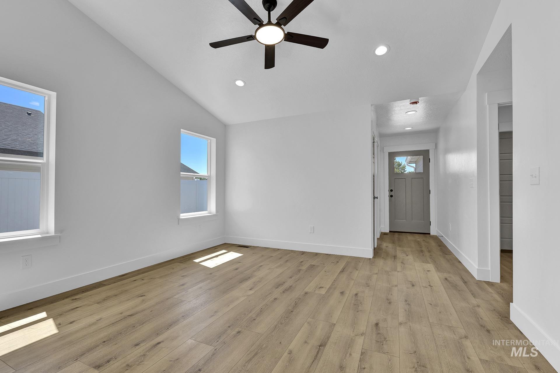 1162 Velvet Loop Wilder, ID 83676 - Photo 6 of 31 Spare room with light wood-type flooring, lofted ceiling, ceiling fan, and recessed lighting