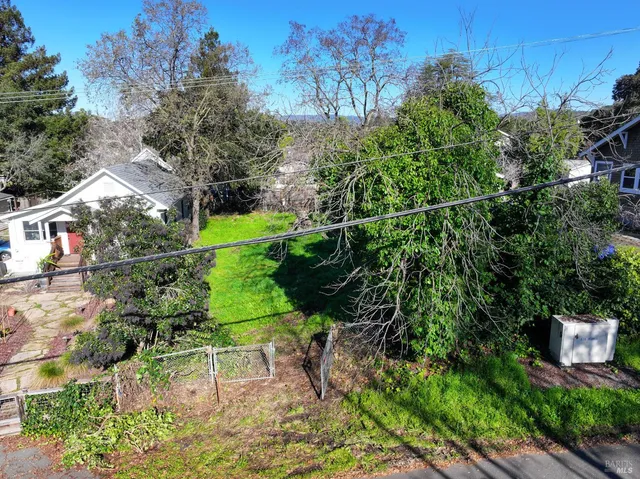 a view of a chair and table on the garden