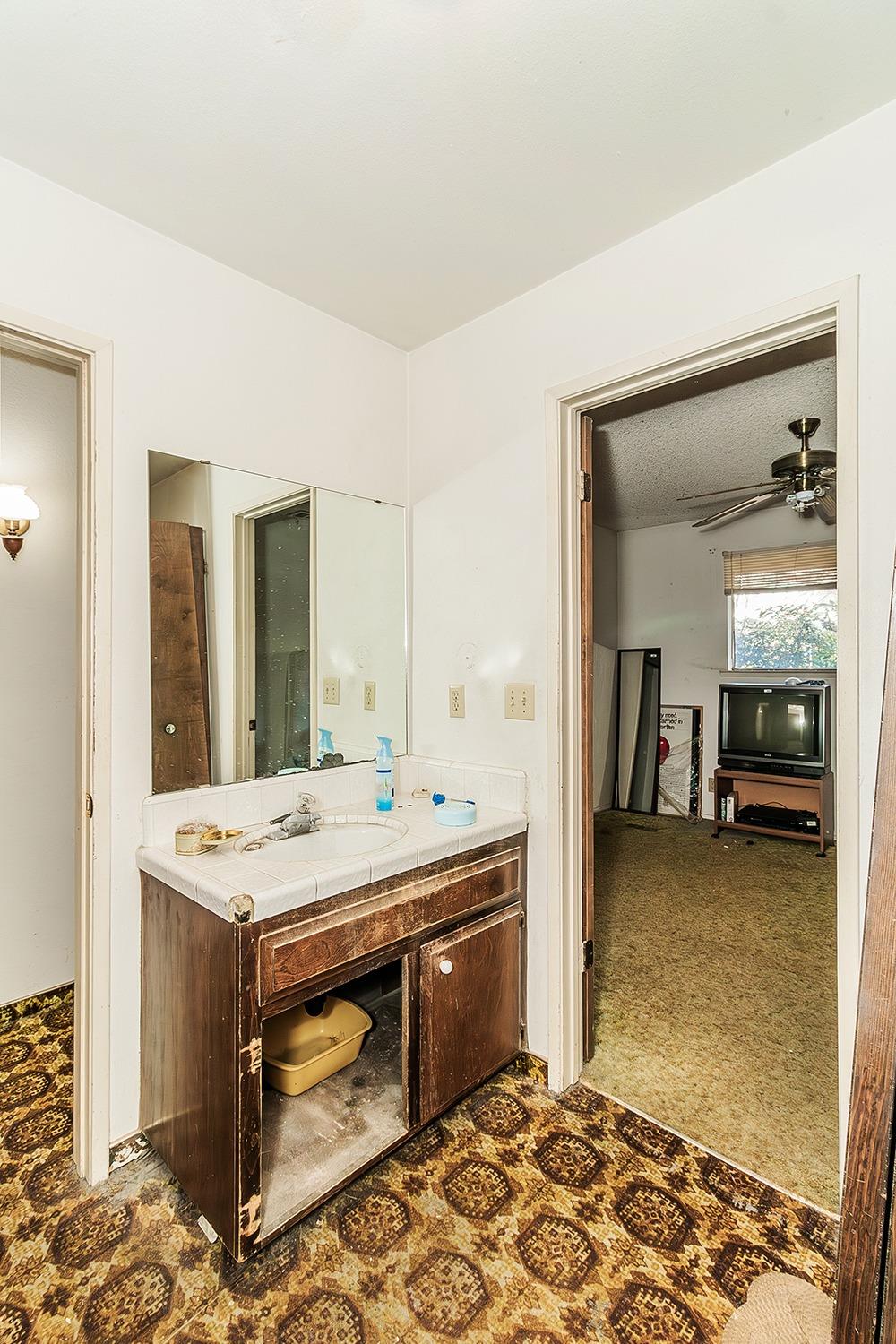 2501 Ashcroft Avenue Clovis, CA 93611 - Photo 16 of 24 a dining room with a sink and a table