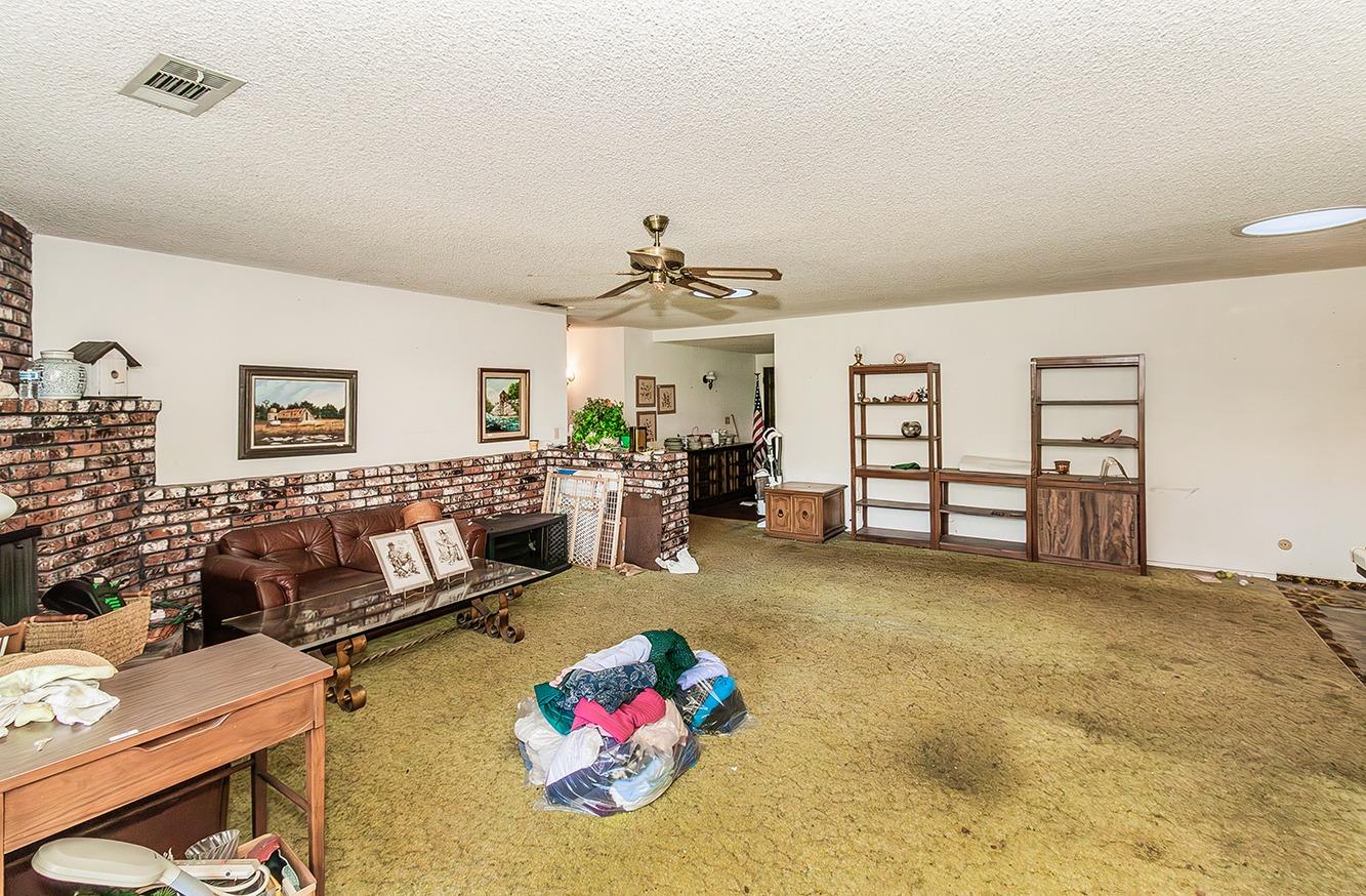 2501 Ashcroft Avenue Clovis, CA 93611 - Photo 7 of 24 a living room with furniture and a chandelier