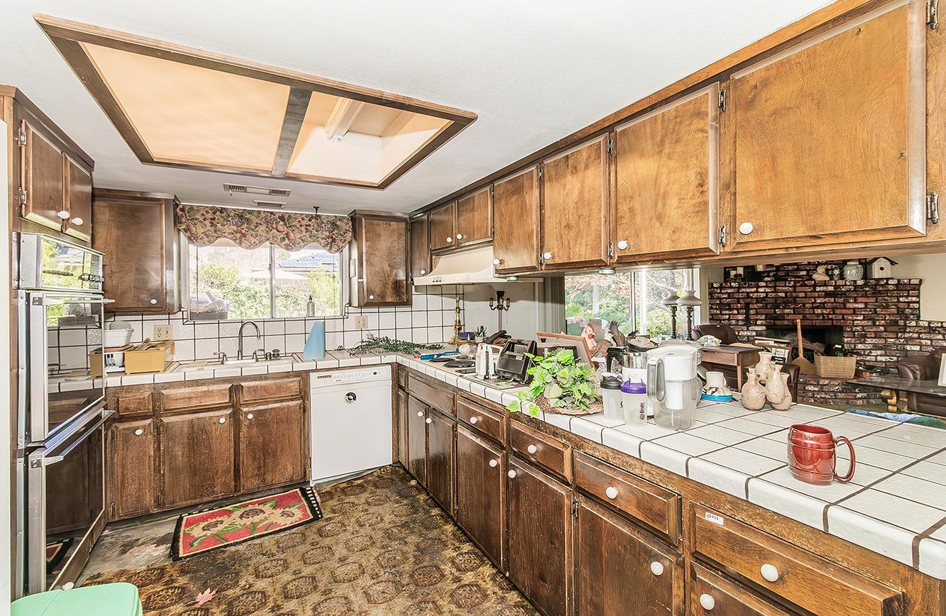2501 Ashcroft Avenue Clovis, CA 93611 - Photo 9 of 24 a kitchen with lots of counter top space and wooden floor