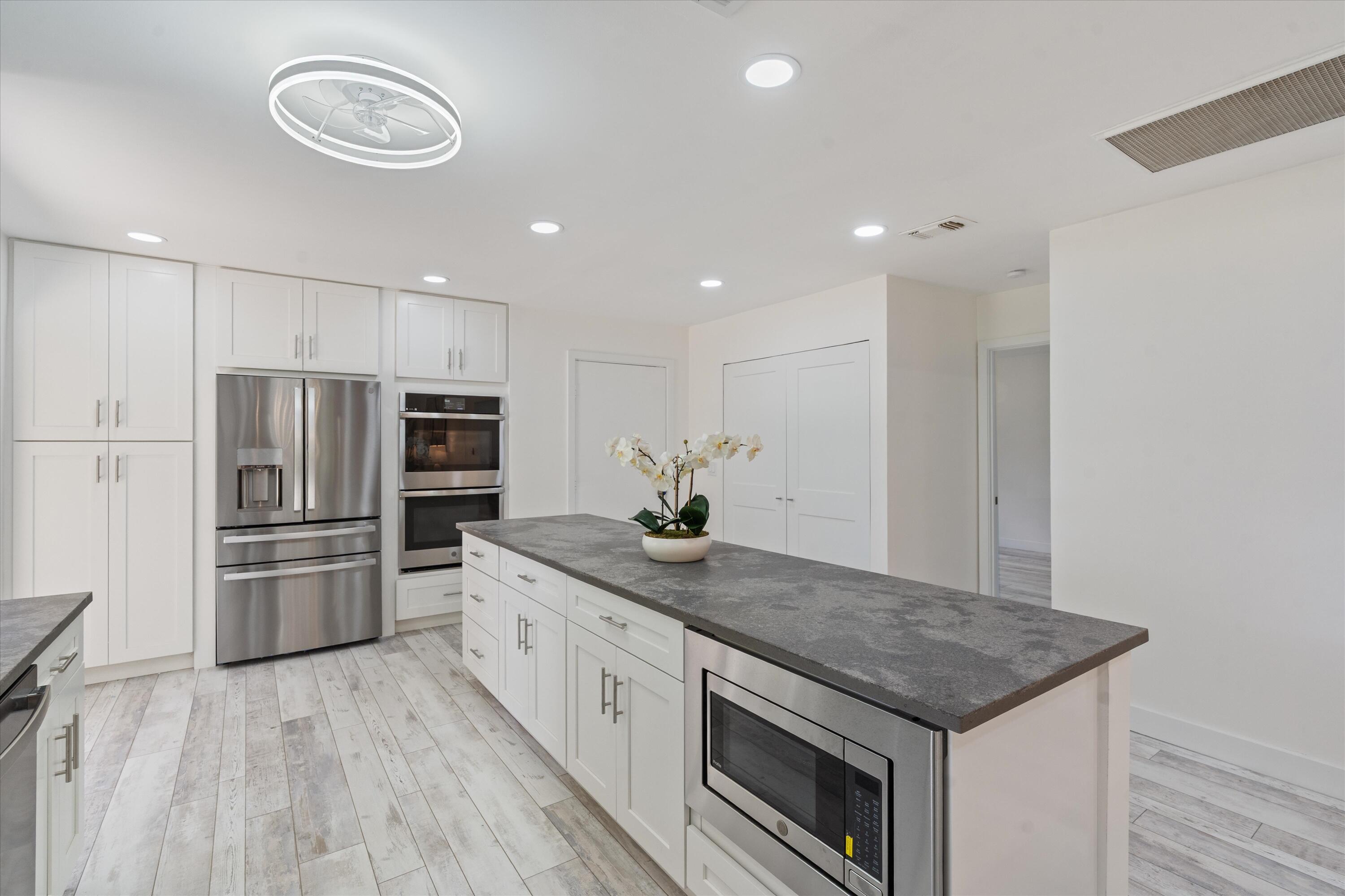 9207 Pecky Cypress Lane, Unit 9B Boca Raton, FL 33428 - Photo 10 of 29 Kitchen Island