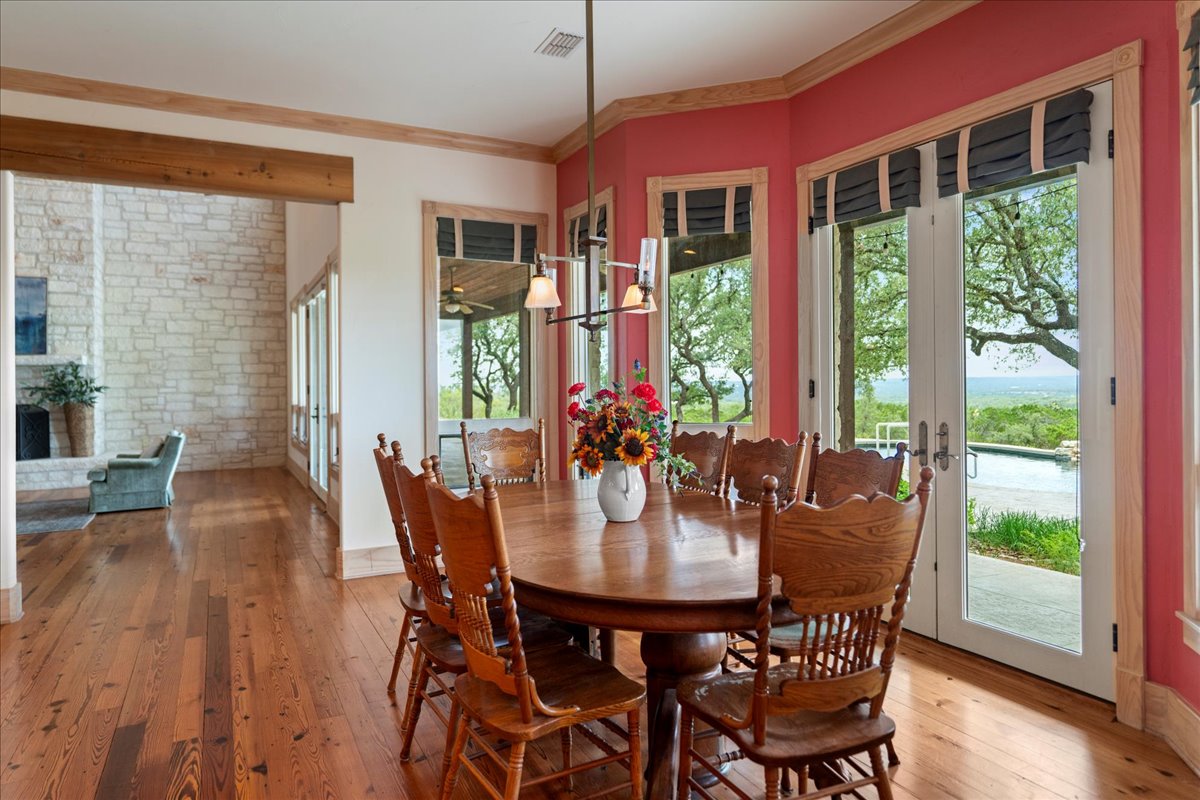 167 Wimberley Ranch Drive Wimberley, TX 78676 - Photo 11 of 40 a view of a dining room with furniture window and wooden floor
