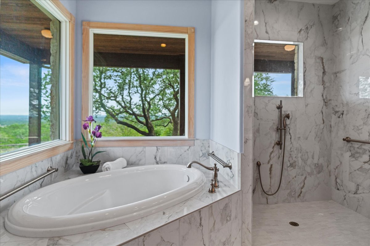 167 Wimberley Ranch Drive Wimberley, TX 78676 - Photo 16 of 40 a white bath tub sitting next to a shower