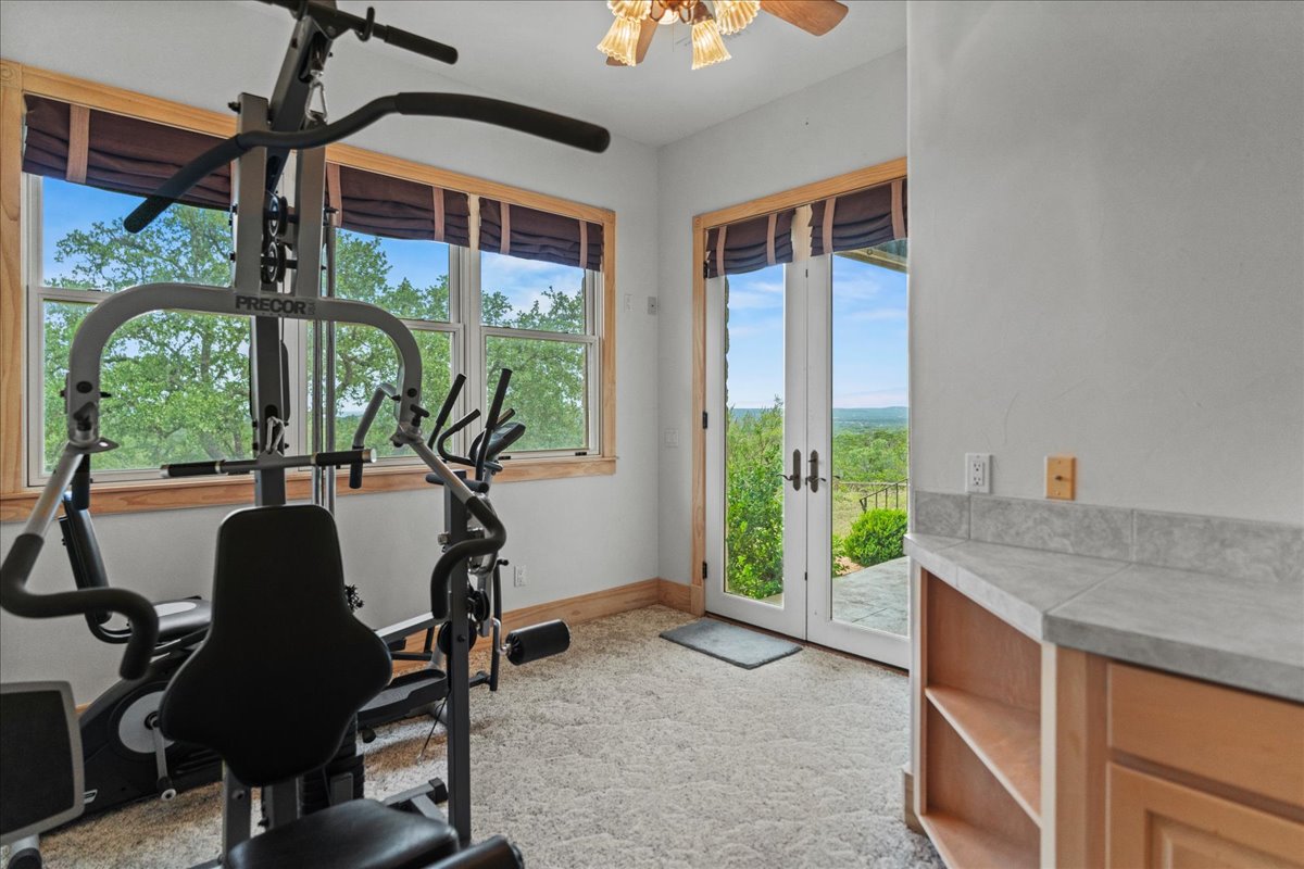 167 Wimberley Ranch Drive Wimberley, TX 78676 - Photo 18 of 40 a room with balcony furniture and a floor to ceiling window