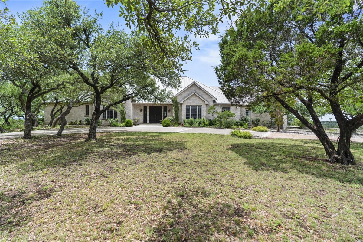 167 Wimberley Ranch Drive Wimberley, TX 78676 - Photo 2 of 40 a front view of a house with a yard