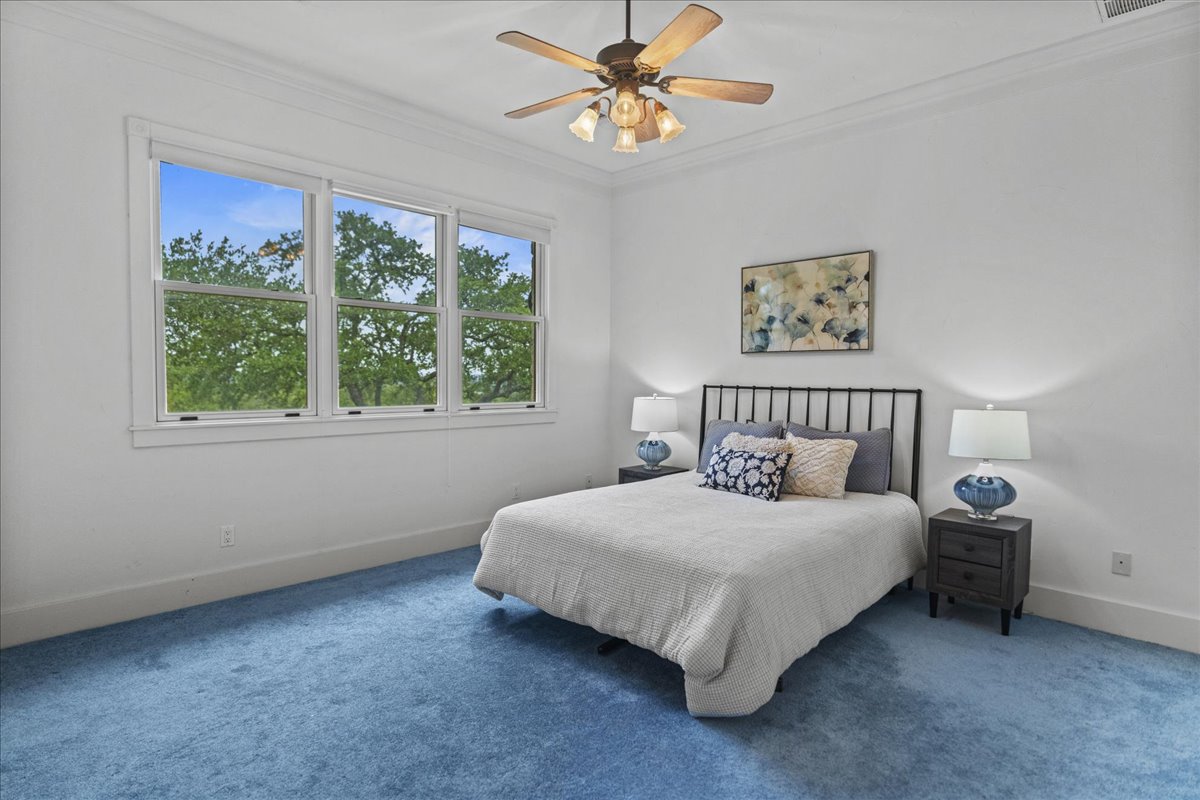 167 Wimberley Ranch Drive Wimberley, TX 78676 - Photo 21 of 40 a bedroom with bed and a window