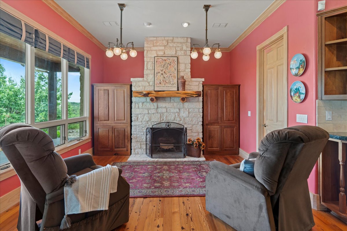 167 Wimberley Ranch Drive Wimberley, TX 78676 - Photo 25 of 40 a living room with furniture chandelier and a fireplace
