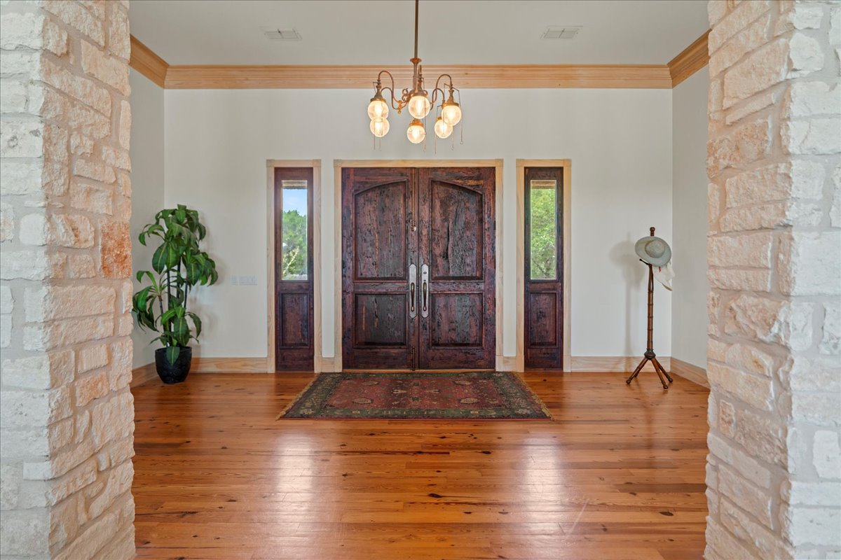 167 Wimberley Ranch Drive Wimberley, TX 78676 - Photo 6 of 40 a view of an entryway with wooden floor and a chandelier