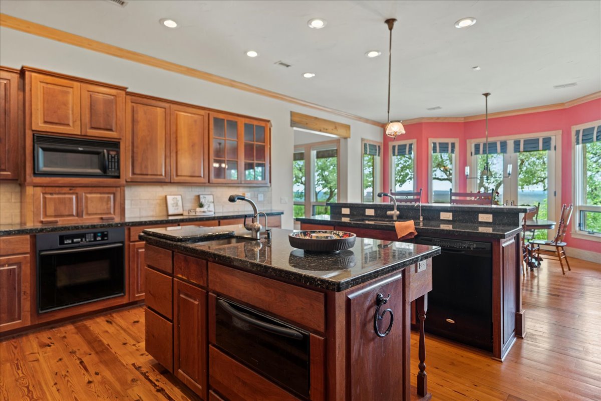 167 Wimberley Ranch Drive Wimberley, TX 78676 - Photo 10 of 40 a kitchen with a stove a sink and a microwave