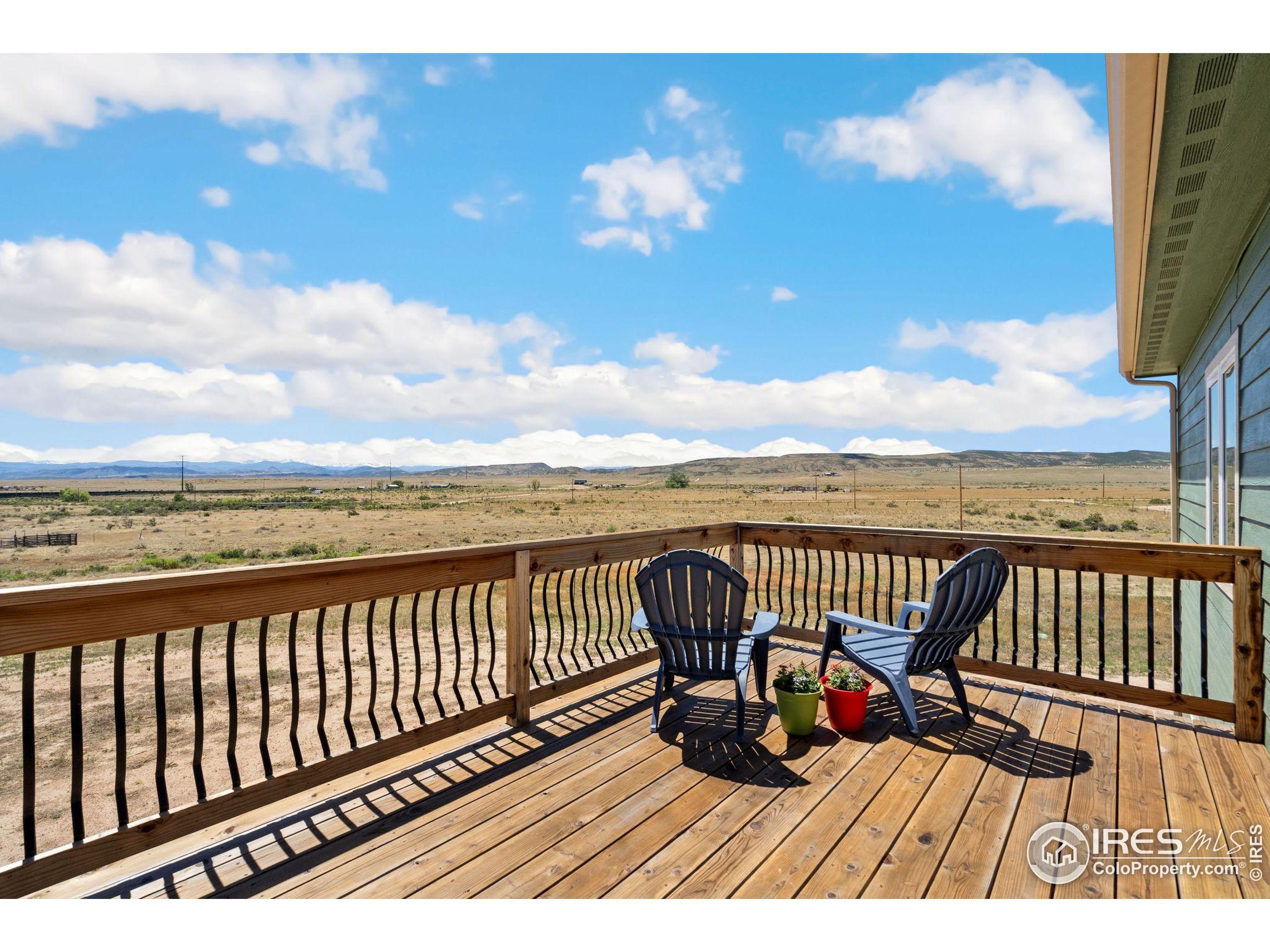 19672 Rawhide Flats Road Wellington, CO 80549 - Photo 12 of 35 a view of balcony with wooden floor