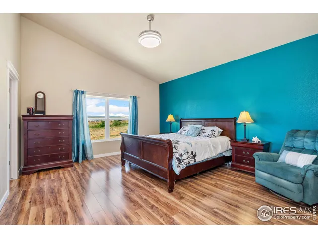 a room with furniture pool table wooden floor and windows