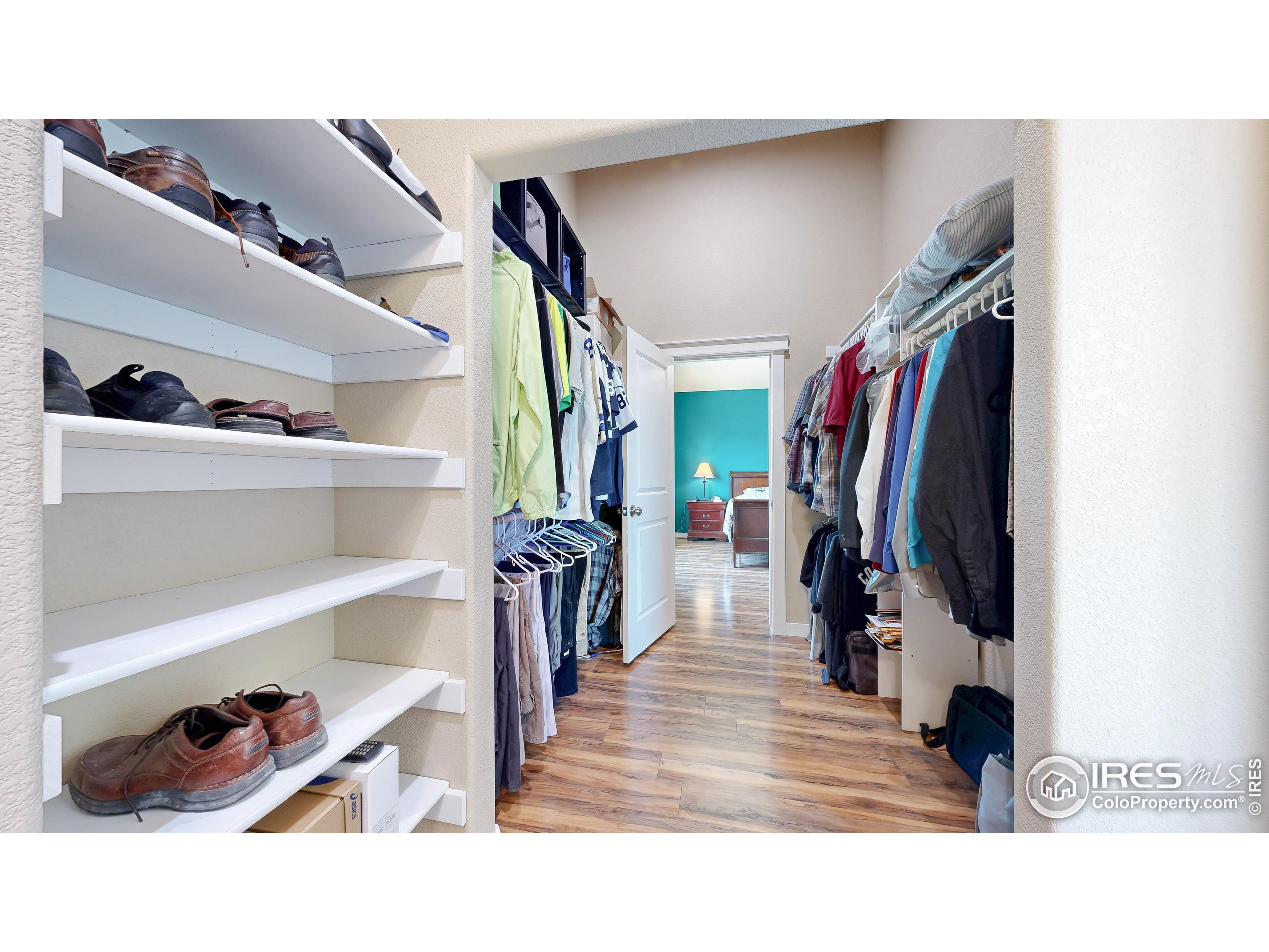 19672 Rawhide Flats Road Wellington, CO 80549 - Photo 19 of 35 a view of walk in closet with clothes and shoes