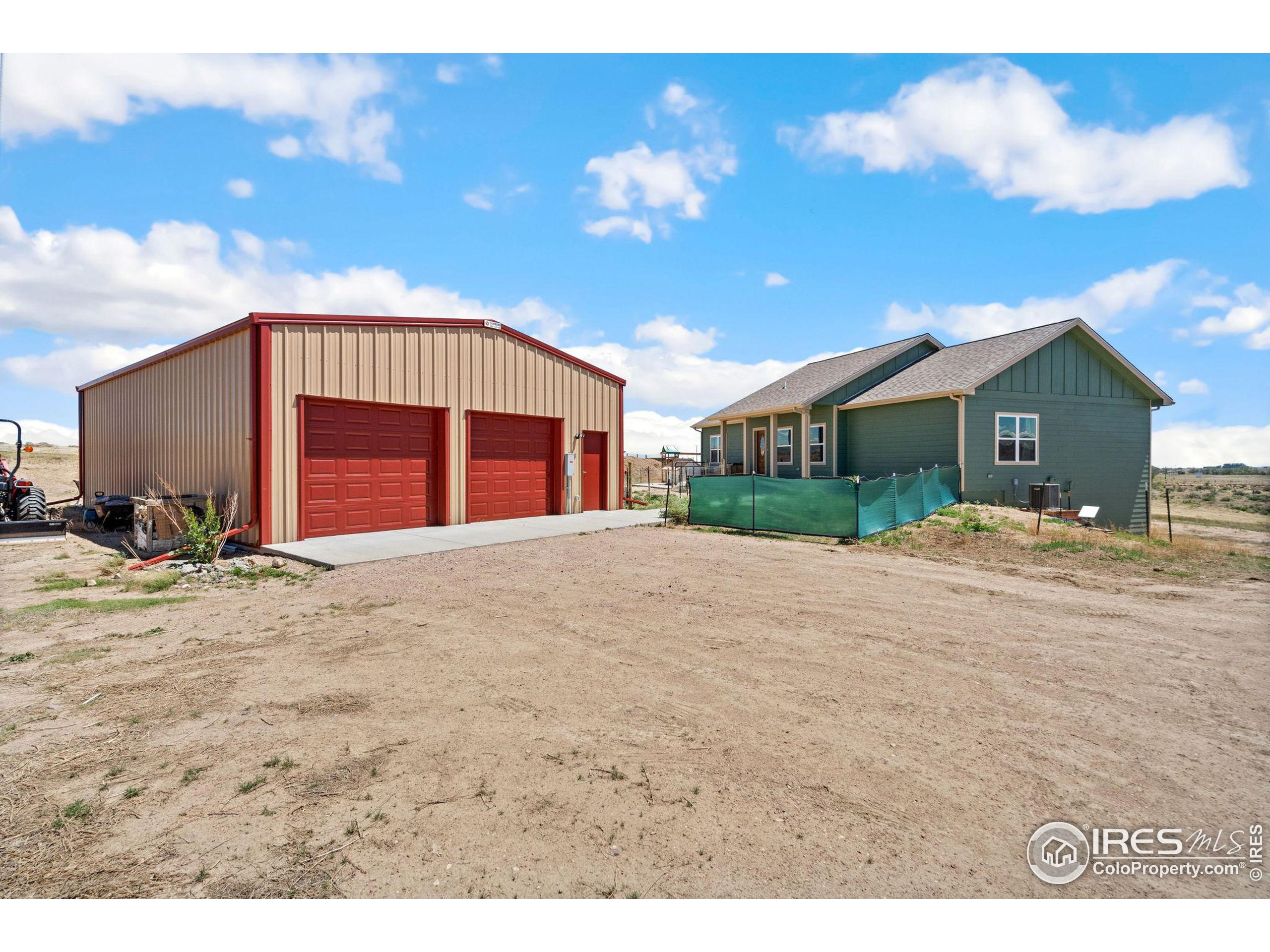 19672 Rawhide Flats Road Wellington, CO 80549 - Photo 2 of 35 a view of a house with a patio