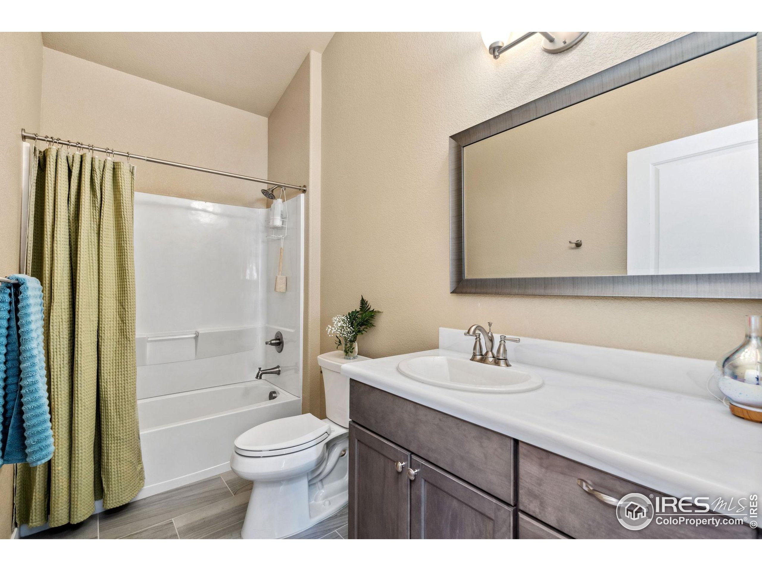 19672 Rawhide Flats Road Wellington, CO 80549 - Photo 21 of 35 a bathroom with a sink a toilet and shower