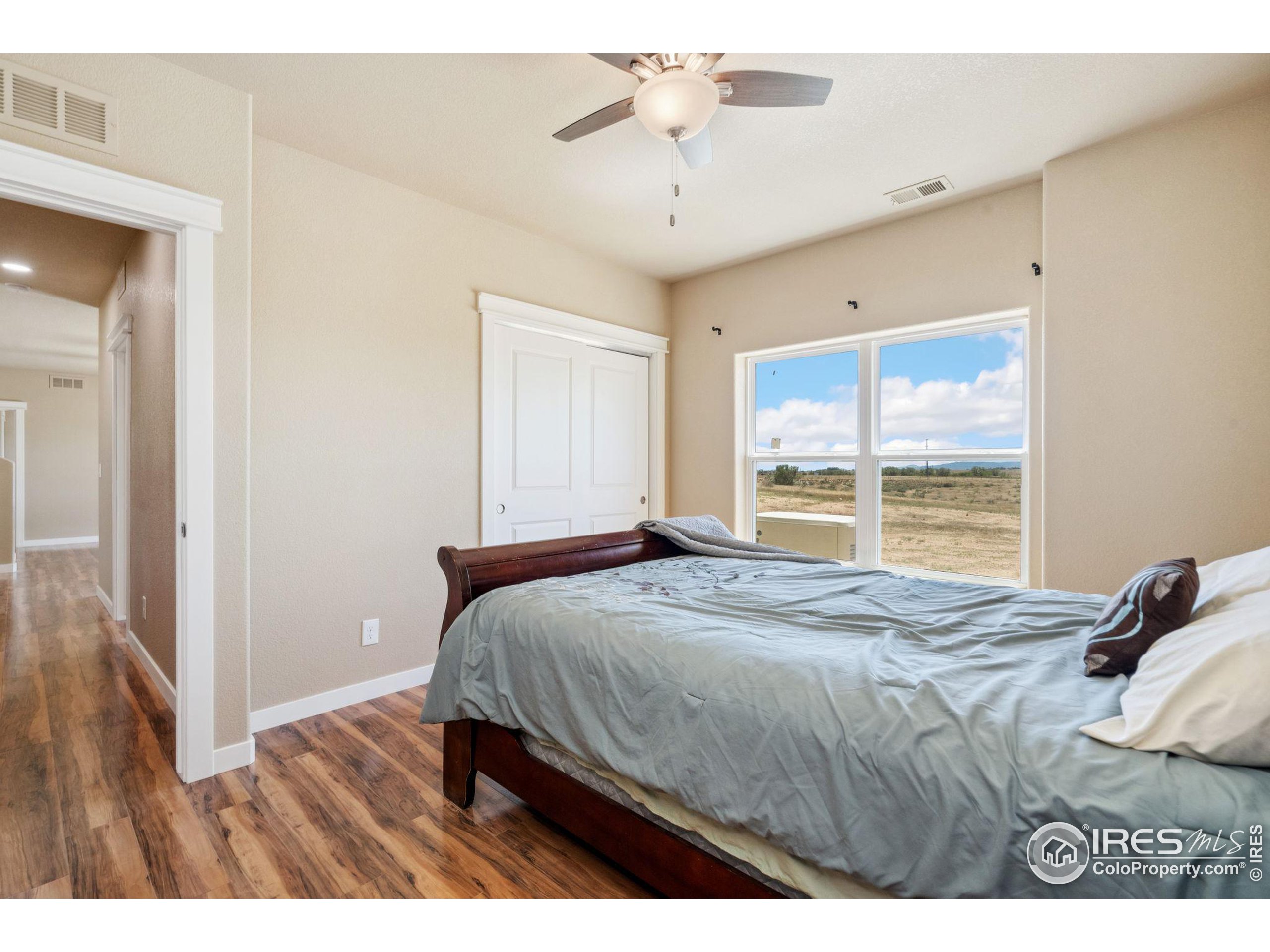 19672 Rawhide Flats Road Wellington, CO 80549 - Photo 25 of 35 a bedroom with a bed and a window