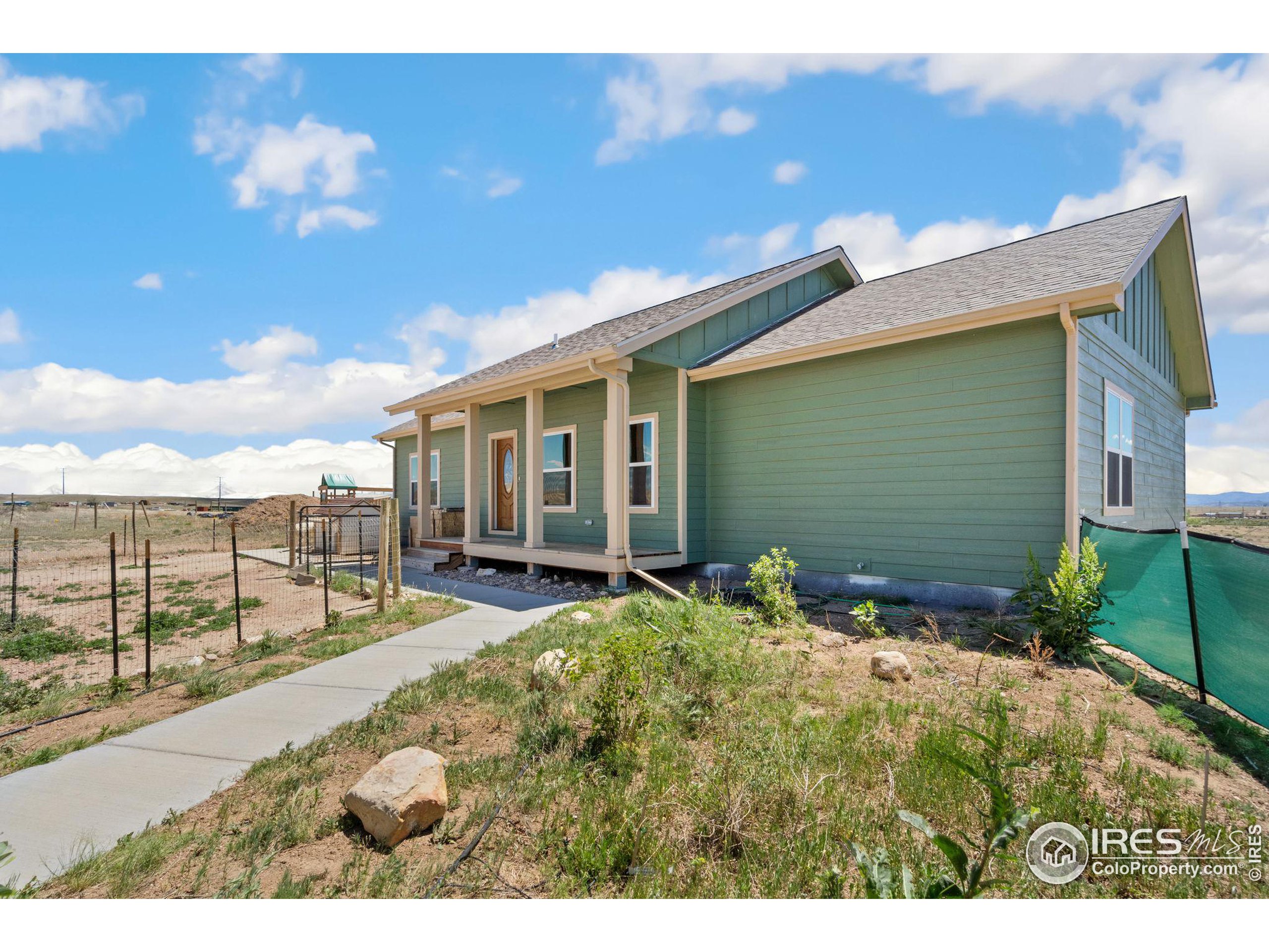 19672 Rawhide Flats Road Wellington, CO 80549 - Photo 30 of 35 a house view with a backyard space
