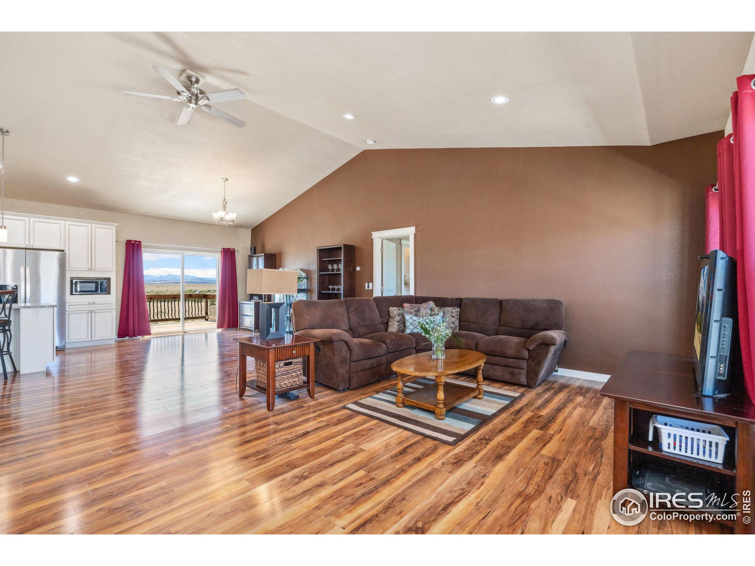 19672 Rawhide Flats Road Wellington, CO 80549 - Photo 4 of 35 a living room with furniture and wooden floor