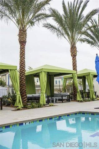 a view of a swimming pool with outdoor seating