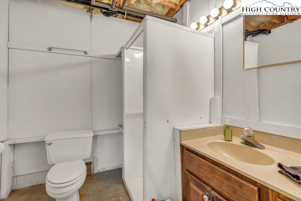 6 Ridgewood Lane Newland, NC 28657 - Photo 29 of 45 a bathroom with a granite countertop sink toilet and shower