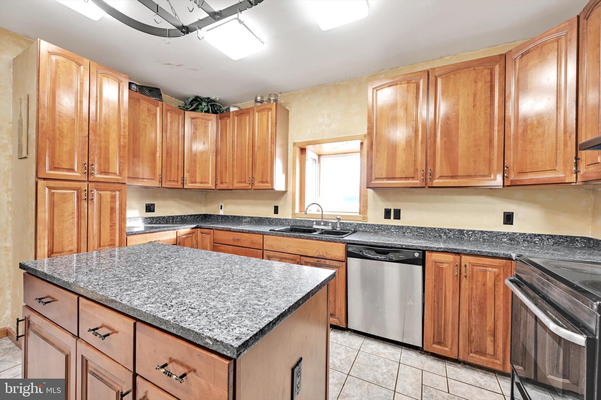 268 West Main Street Ringtown, PA 17967 - Photo 8 of 24 a kitchen with kitchen island granite countertop wooden cabinets a sink and appliances