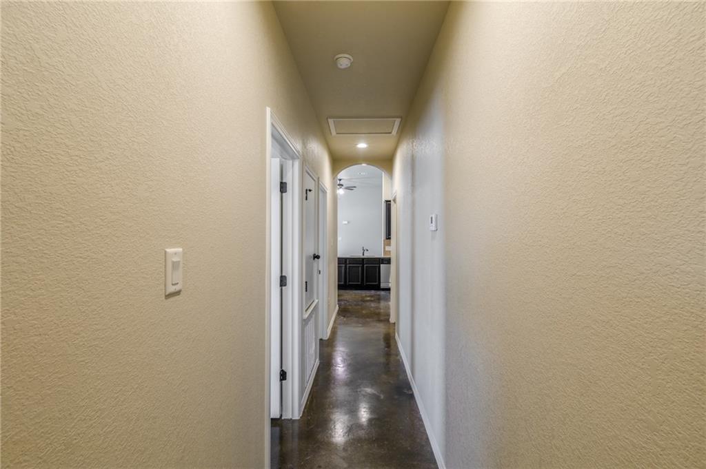 153 Samuel Drive, Unit B Buda, TX 78610 - Photo 12 of 28 a view of a hallway with wooden floor