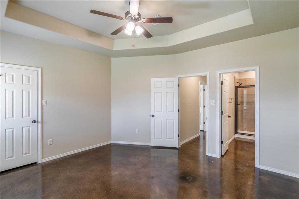 153 Samuel Drive, Unit B Buda, TX 78610 - Photo 13 of 28 an empty room with wooden floor and ceiling fan