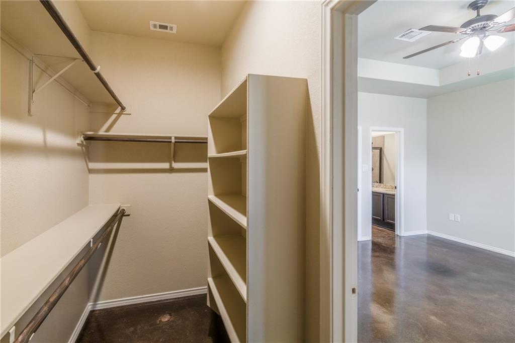 153 Samuel Drive, Unit B Buda, TX 78610 - Photo 16 of 28 a view of walk in closet with clothes and shoes
