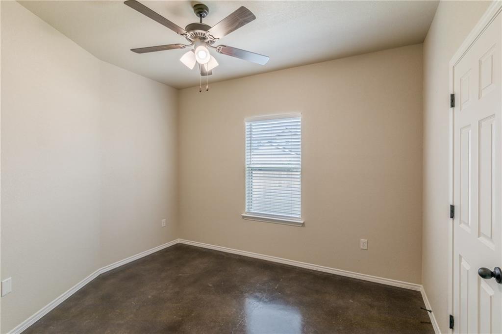 153 Samuel Drive, Unit B Buda, TX 78610 - Photo 17 of 28 an empty room with windows and fan