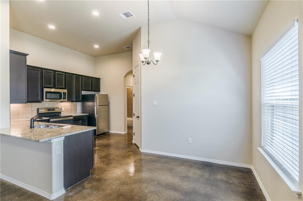153 Samuel Drive, Unit B Buda, TX 78610 - Photo 5 of 28 a kitchen with stainless steel appliances a refrigerator a stove a microwave and island