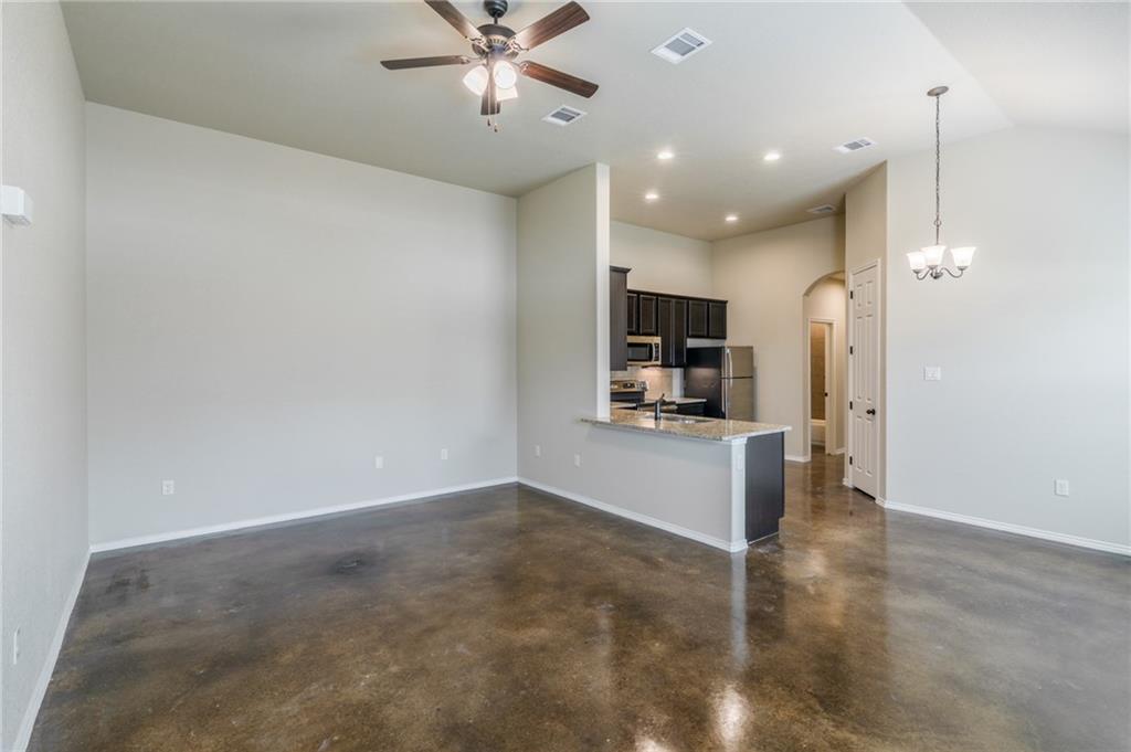 153 Samuel Drive, Unit B Buda, TX 78610 - Photo 6 of 28 a view of a kitchen with a sink and a refrigerator