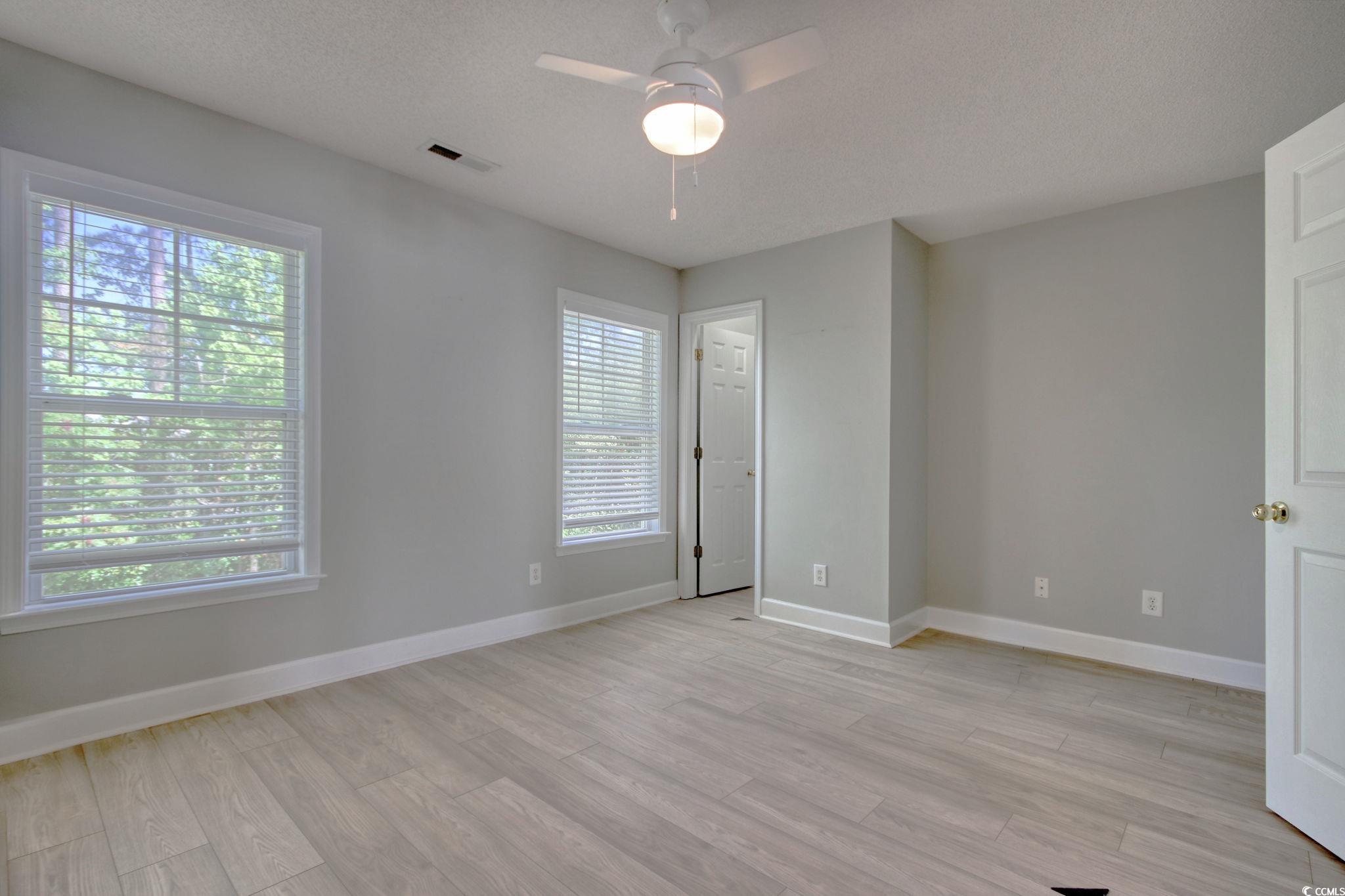 112 Coldstream Cove Loop, Unit 306 Murrells Inlet, SC 29576 - Photo 25 of 32 Upstairs bedroom featuring LVP flooring, walk-in closet and a ceiling fan