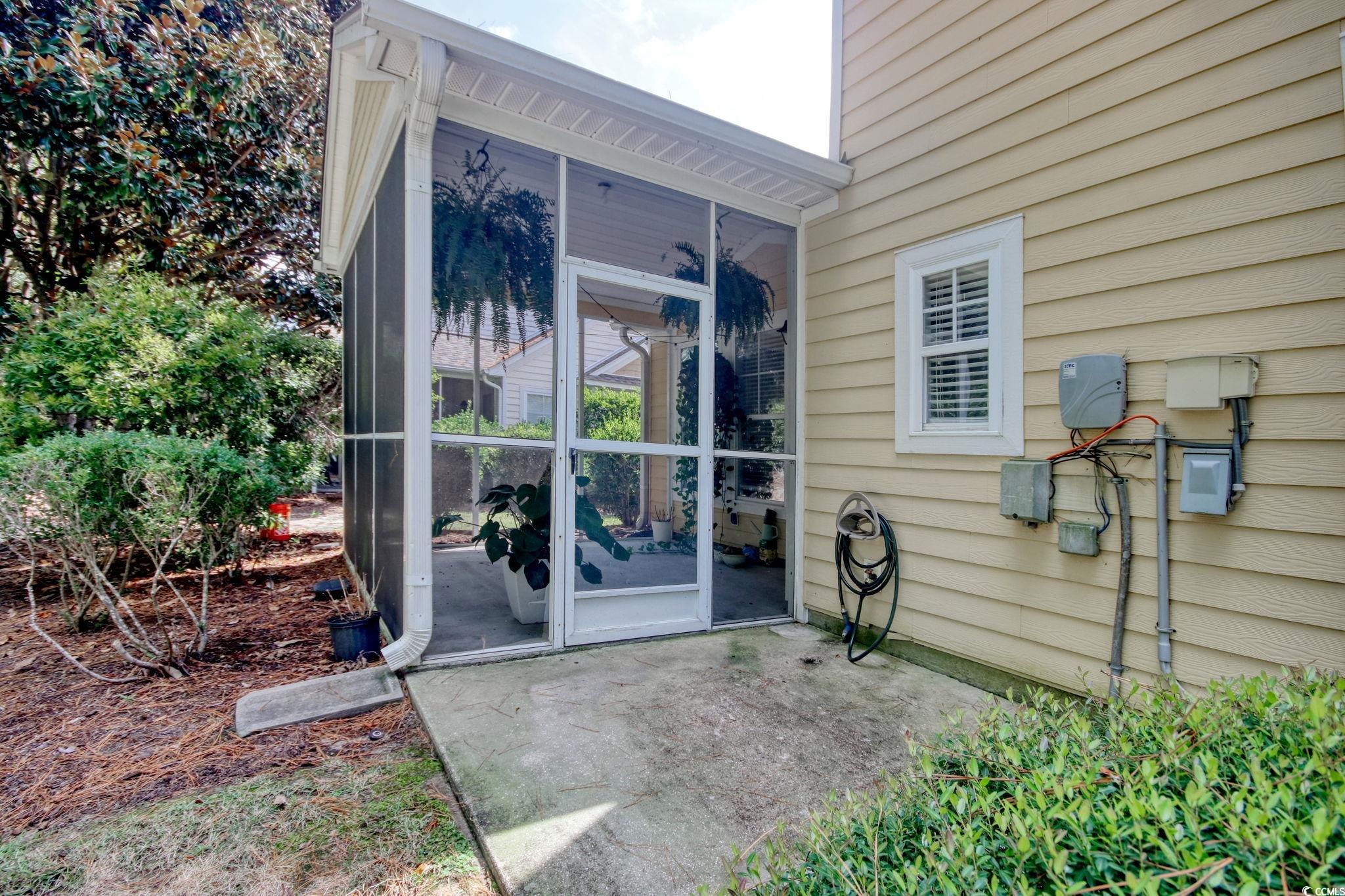 112 Coldstream Cove Loop, Unit 306 Murrells Inlet, SC 29576 - Photo 27 of 32 Screen porch and a patio area