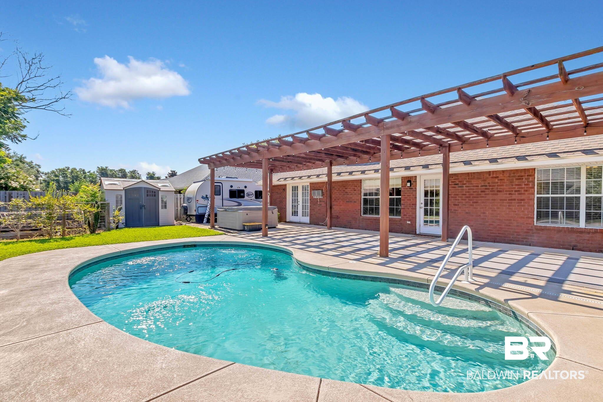 9607 Czar Court Fairhope, AL 36532 - Photo 5 of 42 Outdoor pool with a pergola, a storage shed, a patio, a hot tub, and french doors