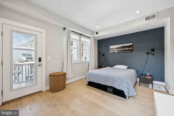 a bedroom with a large bed and a chandelier